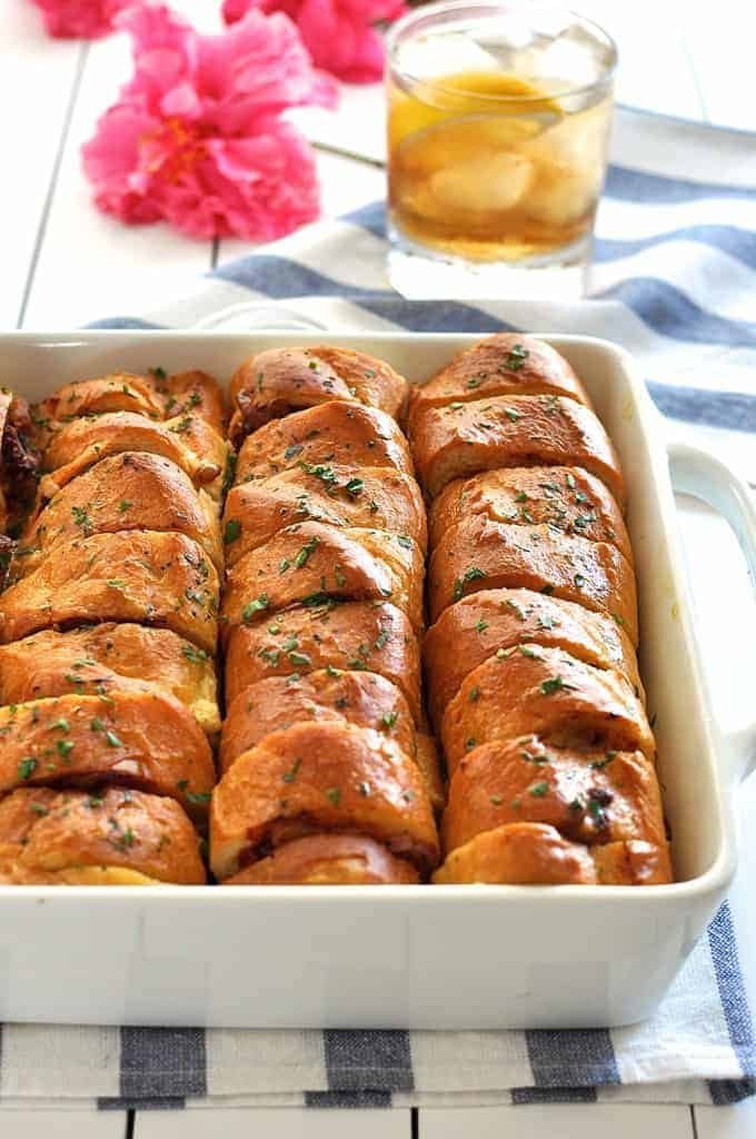 Pulling a piece of Pull Apart Pizza Bread out in a tray