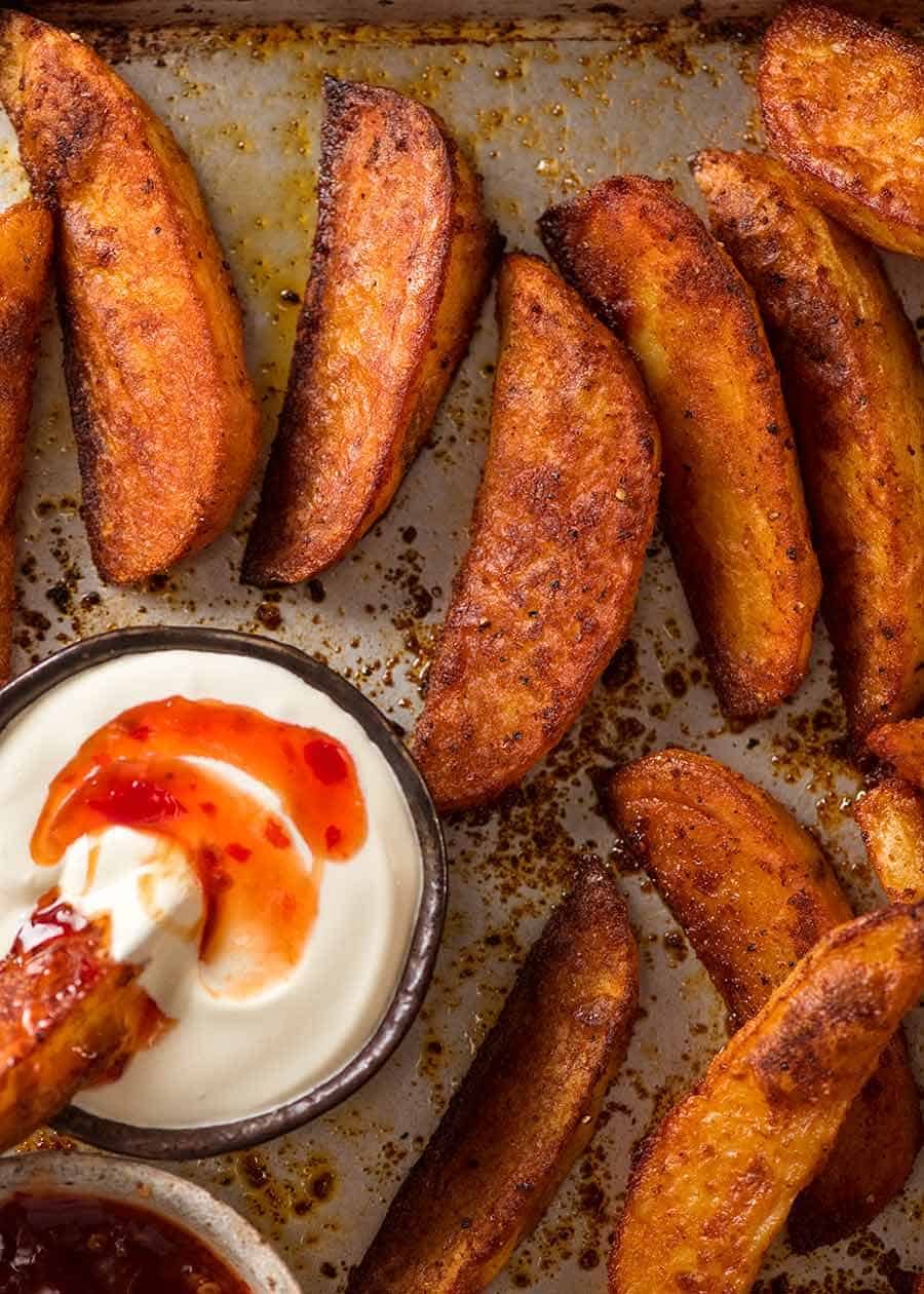 Overhead photo of crunchy baked potato wedges, fresh out of the oven