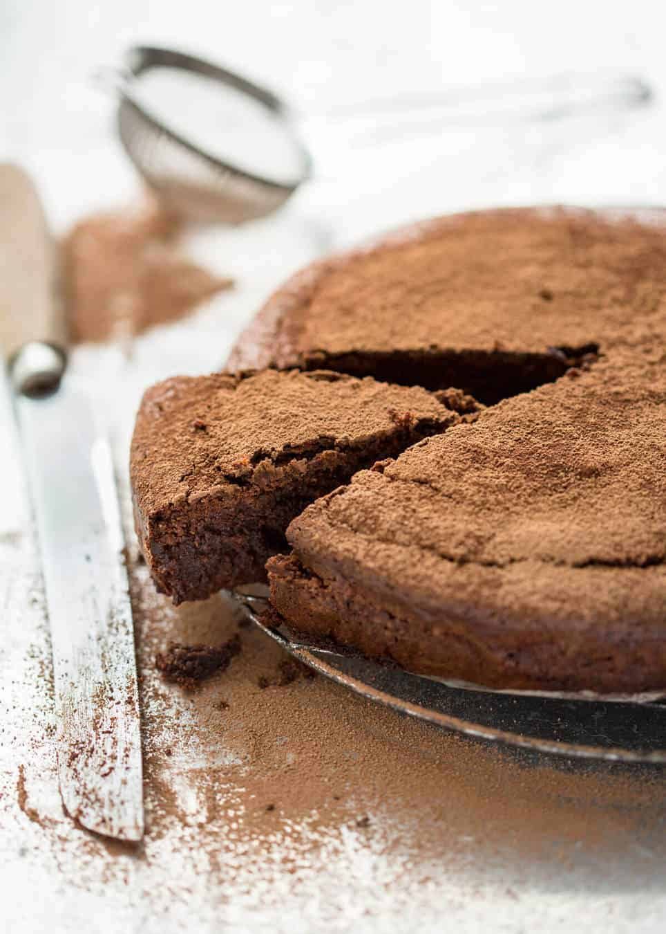 A simple Flourless Chocolate Cake made with almond meal / almond flour. Moist inside, with a thin crackly brownie-like surface. A stunning, very quick cake to make! recipetineats.com