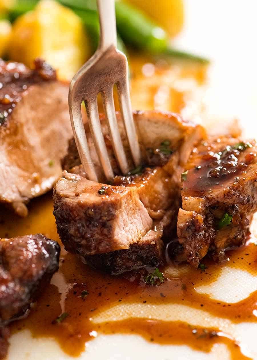 Fork picking up a piece of Honey Garlic Pork Tenderloin