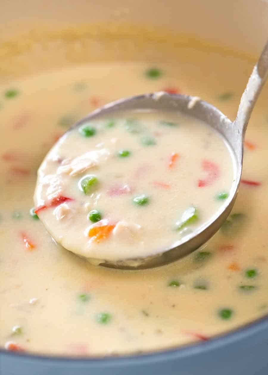 Ladle scooping up Cream of Chicken Soup from pot