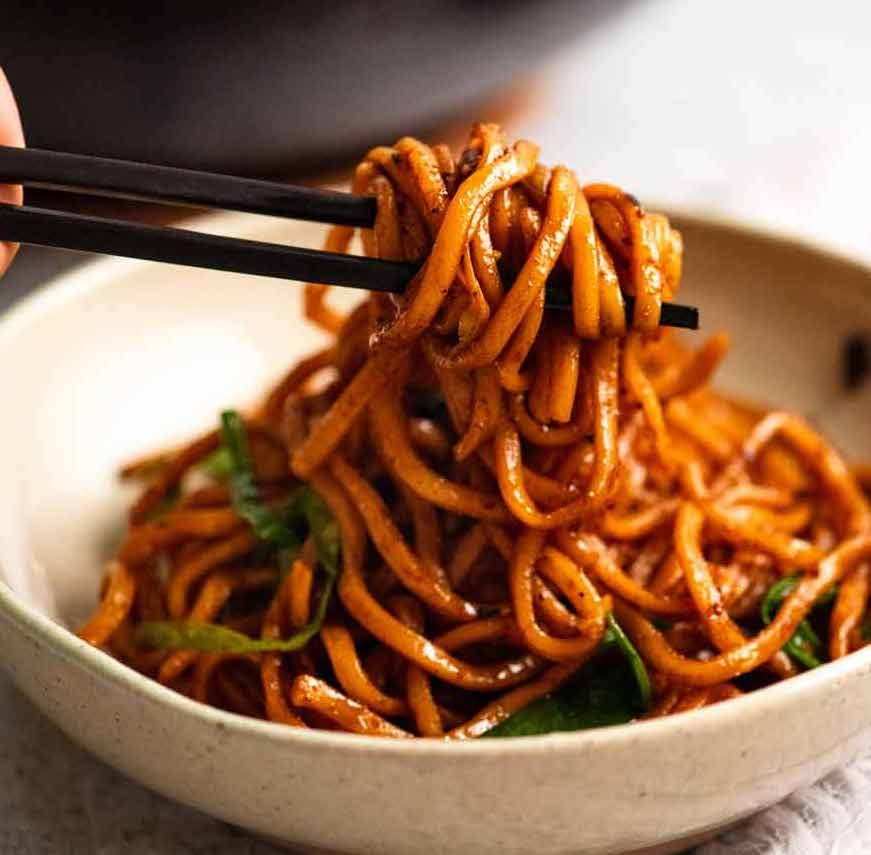 Chopsticks picking up Supreme Soy Noodles